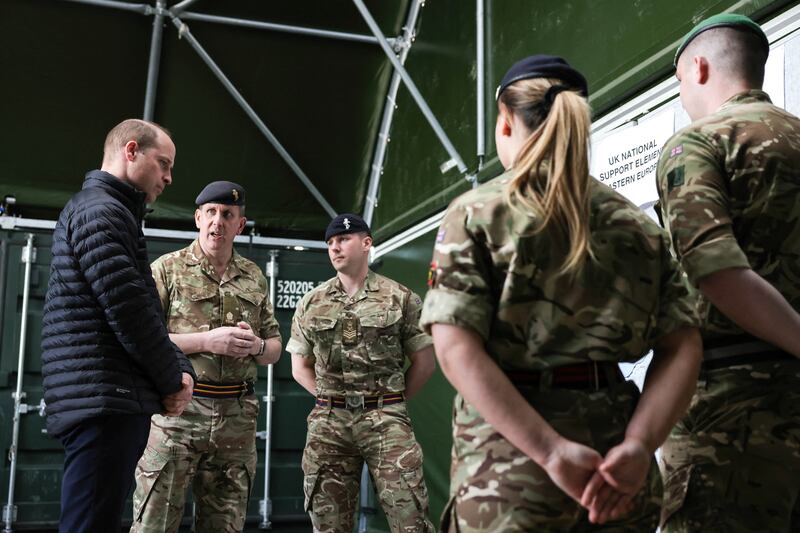 Prince William speaks with servicemembers in Poland. Reuters