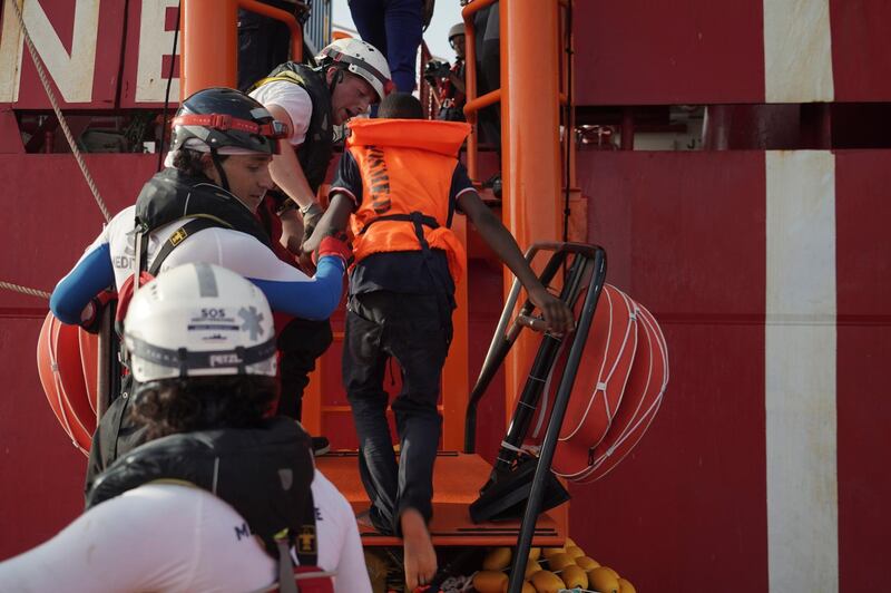 A boy is helped as he boards the Ocean Viking rescue ship in the Mediterranean Sea. The humanitarian ship operated by SOS Mediterranee and Doctors Without Borders pulled over 70 migrants from a rubber boat north of Libya. AP Photo