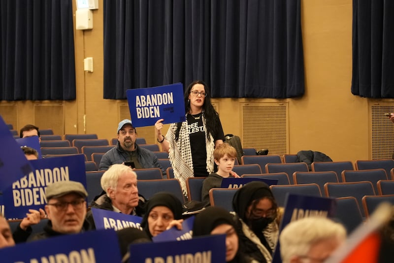 A protester holds up a placard reading 'Abandon Biden' in Dearborn, Michigan. Joshua Longmore / The National