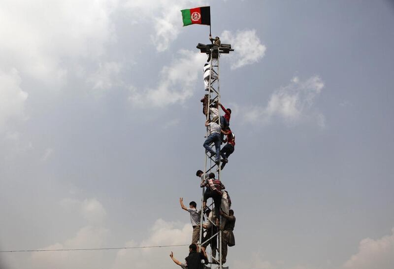 Afghan football fans climb an electrical pole to celebrate winning the South Asian Football Federation championship. Mohammad Ismail / Reuters