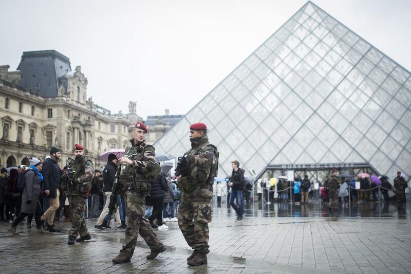 French soldiers on patrol at the Louvre museum in Paris on Saturday, as the museum reopened to the public. Kamil Zihnioglu / AP Photo