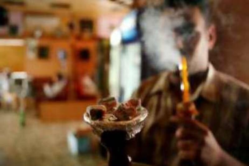 ABU DHABI, UNITED ARAB EMIRATES Ð March 18, 2008: Moustafa Ramadan prepares shisha in an Abu Dhabi Cafe. (Photo by Ryan Carter / The Nation)
 *** Local Caption *** na18shisha.jpg