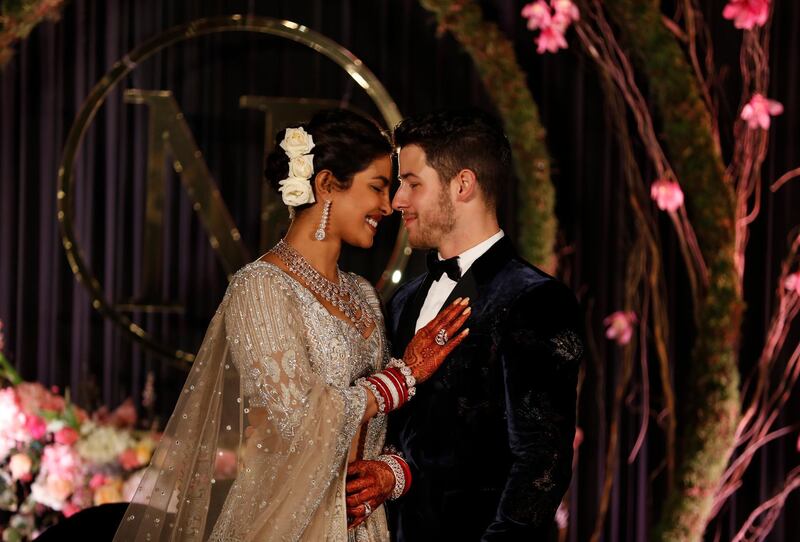 Newlyweds Priyanka Chopra, 36, and Nick Jonas, 26, pose for a photograph during a reception at a hotel in New Delhi on December 4, 2018. Photo: AP