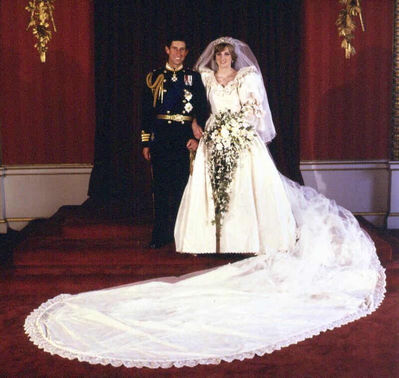 File photo dated 29/07/1981 or The Prince and Princess of Wales at Buckingham Palace after their wedding at St Paul's Cathedral. A copy of the wedding dress worn by Diana, Princess of Wales, which went under the hammer for £100,000 Wednesday December 7, 2005. See PA story SALE Dress. PRESS ASSOCIATION Photo. Photo credit should read: PA Images via Reuters