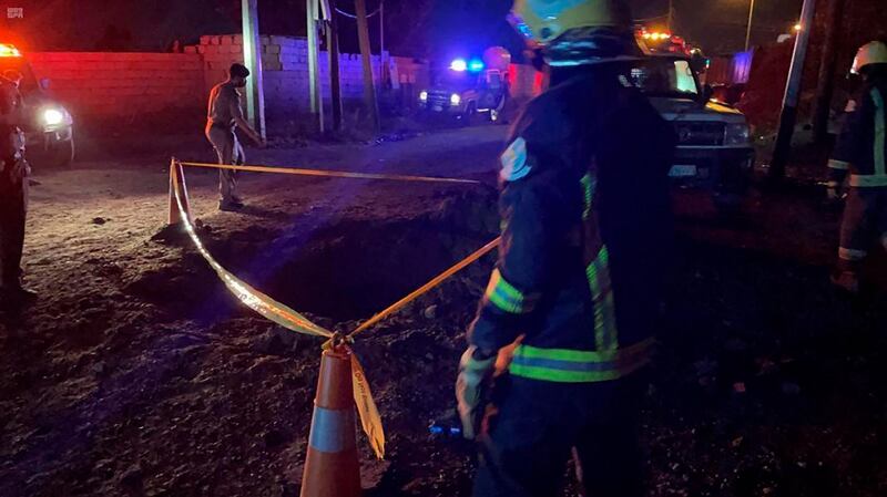 Civil defence personnel surround a crater in the Saudi Arabian port city of Jazan, after a projectile was fired by Houthi rebels in Yemen. SPA via AP