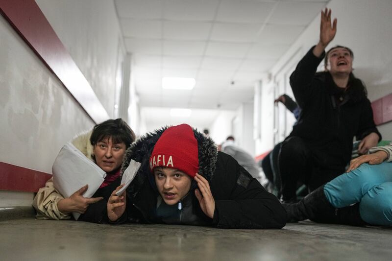 People lie on the floor of a hospital during shelling by Russian forces. AP Photo