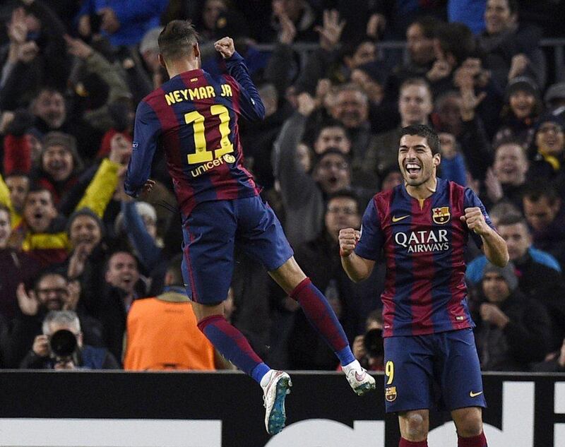 Barcelona's Neymar celebrates with teammate Luis Suarez after scoring the eventual winner in Barca's 3-1 victory over Paris Saint-Germain on Wednesday night in the Champions League. Lluis Gene / AFP / December 10, 2014 