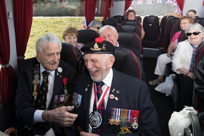 Bill Pendall, 96, who landed as a courier, from the 11th Armored Division, on D-Day at Gold Beach and Joe Cattini 95, who was in the Hertfordshire Yeomanry joke as they get on the coach that will take them to Normandy in France. Matt Cardy / Getty Images