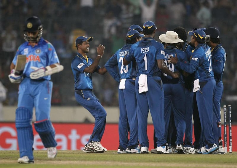 India’s Ajinkya Rahane , left, leaves the field as Sri Lanka’s fielders celebrate his dismissal in the ICC Twenty20 World Cup final at the Sher-E-Bangla National Cricket Stadium in Dhaka on April 6, 2014. Andrew Biraj / Reuters