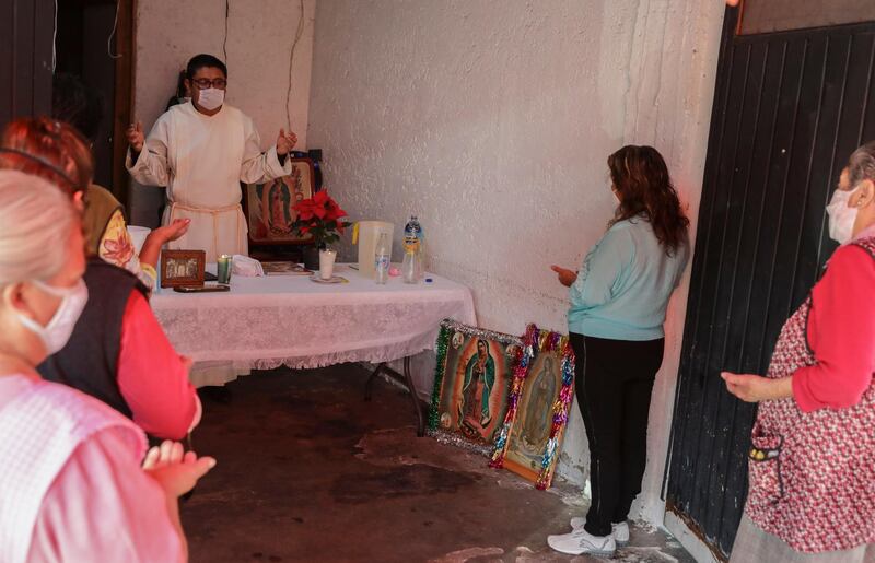 Residents attend a Mass inside a house in honor of the Virgin of Guadalupe, in Mexico City.  AP