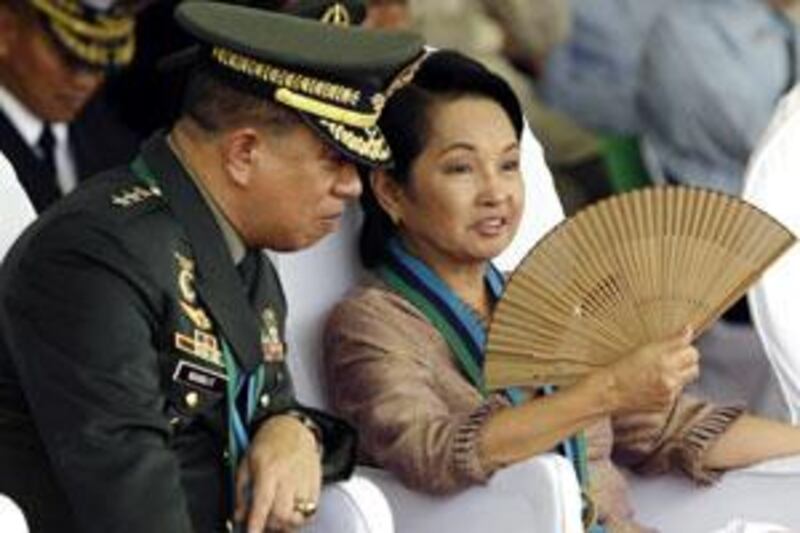 President Gloria Macapagal Arroyo talks to her new chief of staff Lt Gen Delfin Bangit, known to the people as 'the emperor', during the Change of Command ceremony 10 days ago.
