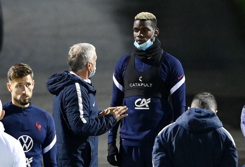 France' manager Didier Deschamps talking to Paul Pogba at training. AFP