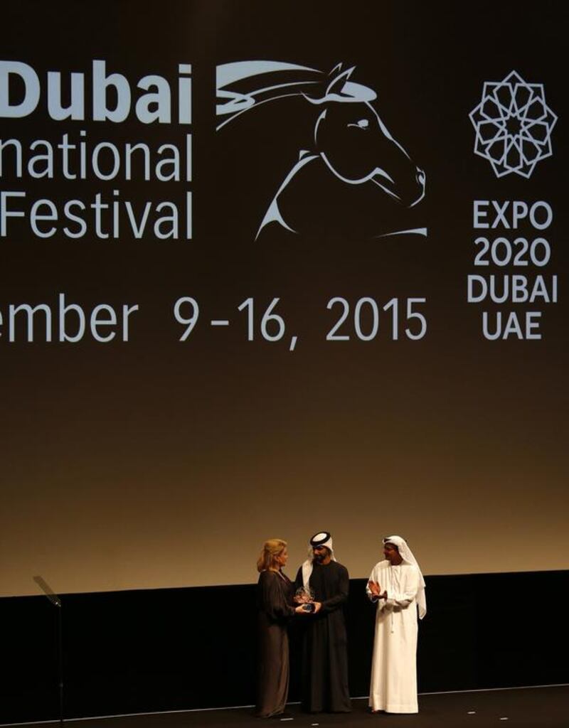 Catherine Deneuve receives a lifetime achievement award from Sheikh Mansoor bin Mohammed at the Dubai International Film Festival. Karim Sahib / AFP Photo