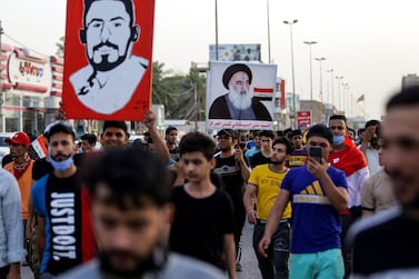 Protesters chant slogans as they march in a demonstration in Iraq's central holy shrine city of Najaf. One person is holding up a picture of Shiite Muslim Grand Ayatollah Ali Sistani. AFP