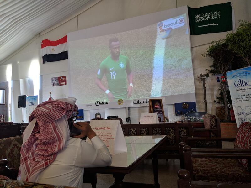 A football fan watches the World Cup group game between Saudi Arabia and Egypt at a cafe in Jeddah. Naser Al Wasmi / The National
