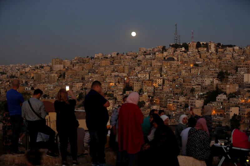 People wait for the lunar eclipse at Amman Citadel in Jordan July 27, 2018. REUTERS/Muhammad Hamed