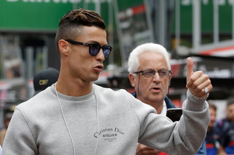 Cristiano Ronaldo applauds fans at the pit line ahead of the second practice session in Monaco. AP Photo