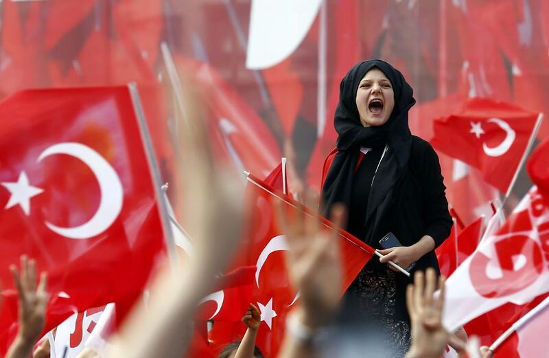 Supporters of Turkish President Tayyip Erdogan wave national flags during a rally for the upcoming referendum in Konya, Turkey. Umit Bektas / Reuters