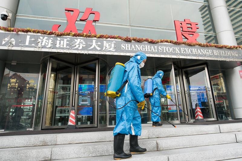 SHANGHAI, CHINA - FEBRUARY 03: Medical workers spray antiseptic outside of the main gate of Shanghai Stock Exchange Building on February 03, 2020 in Shanghai, China. (Photo by Yifan Ding/Getty Images)