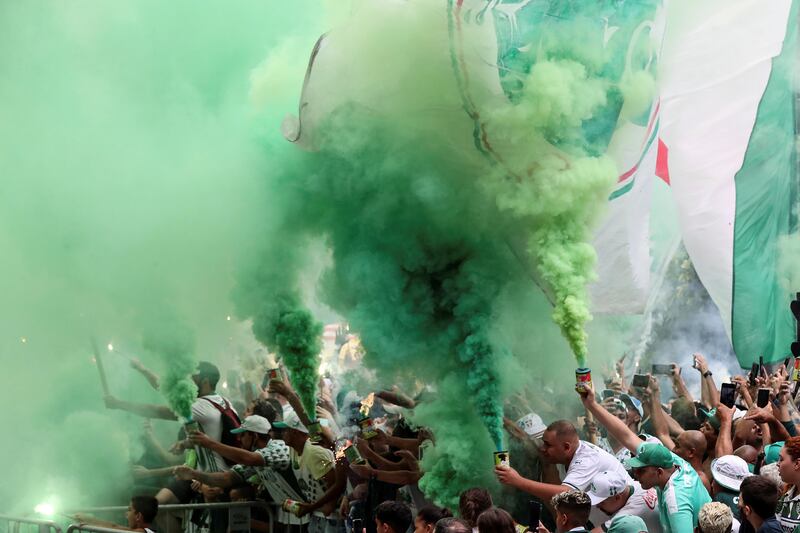 Palmeiras fans cheer as the team bus exits the training centre in Sao Paulo, Brazil. Palmeiras are on their way to Abu Dhabi to take part in the Fifa Club World Cup. EPA