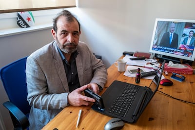 Syrian human rights lawyer Anwar al-Bunni poses in his office in Berlin on April 9, 2020. - When Anwar al-Bunni crossed paths with fellow Syrian Anwar Raslan in a DIY store in Germany five years ago, he recognised him as the man who had thrown him into prison around a decade earlier. On Thursday, April 23, 2020 the two men will face each other in a German court, where Raslan will be one of two alleged former Syrian intelligence officers in the dock accused of carrying out crimes against humanity for Bashar al-Assad's regime. (Photo by John MACDOUGALL / AFP)