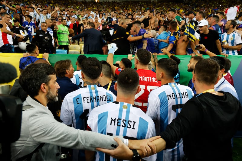 Lionel Messi and his Argentina teammates react as police officers clash with fans. Getty Images