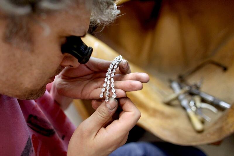 A  Garrard jeweller examines a diamond earring in  London. Oli Scarff / Getty Images