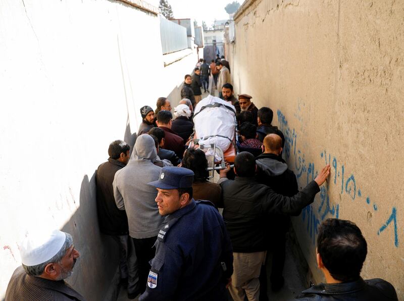 Relatives carry the body of one of the female judges shot dead by unknown gunmen in Kabul, Afghanistan. Reuters