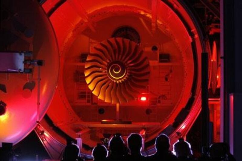 Visitors stand in front of the festively illumunated interior of a vacuum chamber for engine tests at the Rolls-Royce Mechanical Test Operations Centre (MTOC) in Dahlewitz, eastern Germany, on May 4, 2010. The centre, which employs 70 technicians and engineers, was inaugurated after a construction period of one and a half year.    AFP PHOTO    DDP/SEBASTIAN WILLNOW    GERMANY OUT