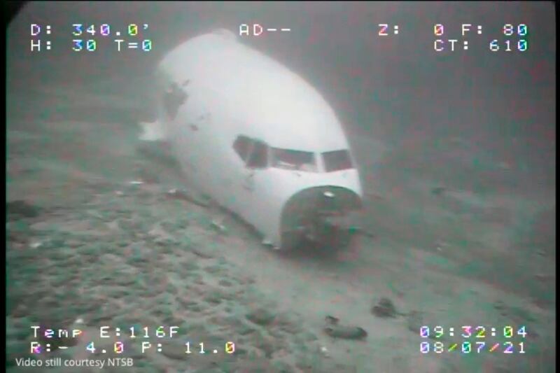 In this Thursday, July 8, 2021 image from video provided by the National Transportation Safety Board, the jet cabin from Transair Flight 810 rests on the Pacific Ocean floor off the coast of Honolulu, Hawaii.  The NTSB located the aircraft on the Pacific Ocean floor approximately 2 miles from Ewa Beach.  The fuselage split into 2 sections, breaking just forward of the wings.  On July 2, the pilots of the Transair Flight 810 reported engine trouble and were attempting to return to Honolulu when they were forced to land the Boeing 737 in the water, the Federal Aviation Administration said in a statement.  (NTSB via AP)