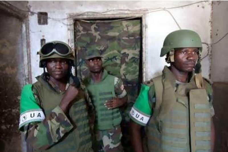 Soldiers of the African Union Mission in Somalia (AMISOM) stand at the entrance of the strategic "K4" base in Mogadishu, on November 24, 2009. Somalia's embattled president appealed to the international community on November 24, to do more to prop up his transitional government, fighting for survival against an Al Qaeda-inspired insurgency. AFP PHOTO / YASUYOSHI CHIBA