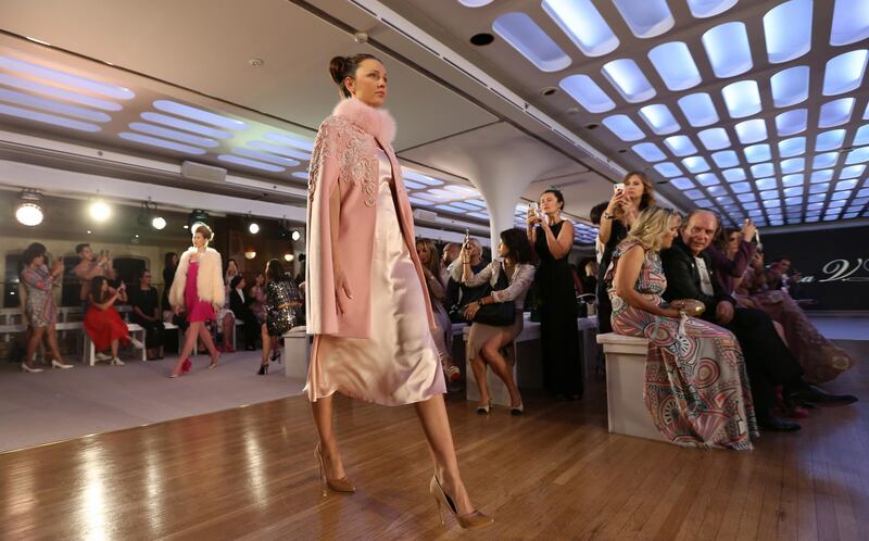 epa06723941 A model displays a creation from the collection of Russian designer Tatiana V. Lyalina during the first floating fashion week experience of the Arab Fashion Week held at the Queen Elizabeth II Ship naval hotel at Port Rashid in Dubai, United Arab Emirates, 09 May 2018.  EPA/ALI HAIDER