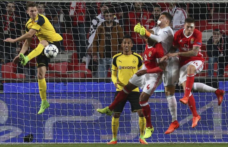 Dortmund's Lukasz Piszczek, left, jumps for the ball. Armando Franca / AP