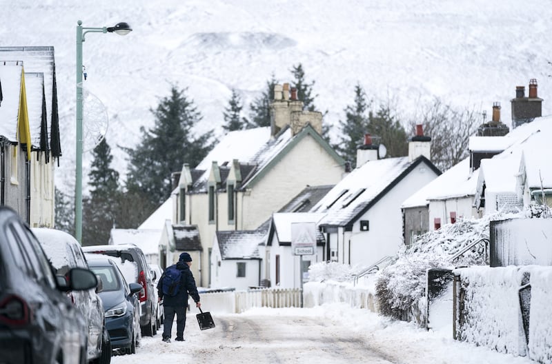 A man clears snow away in Leadhills, South Lanarkshire, as Storm Barra hits the UK and Ireland with disruptive winds, heavy rain and snow. PA