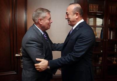 Turkey's Foreign Minister Mevlut Cavusoglu, right, and U.S. Republican Senator Lindsey Graham shake hands before a meeting in Ankara, Turkey, Friday, Jan. 18, 2019. Graham has discussed the situation in Syria with Cavusoglu and Turkey's President Recep Tayyip Erdogan as the United States prepares to withdraw troops.(Turkish Foreign Ministry Press Service via AP, Pool)