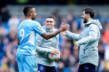 Manchester City's Gabriel Jesus, left, celebrates with teammates Phil Foden and Bernardo Silva, right, at the end of the English Premier League soccer match between Manchester City and Watford at Etihad stadium in Manchester, England, Saturday, April 23, 2022.  Jesus scored four goals in Manchester City's 5-1 win.  (AP Photo / Jon Super)