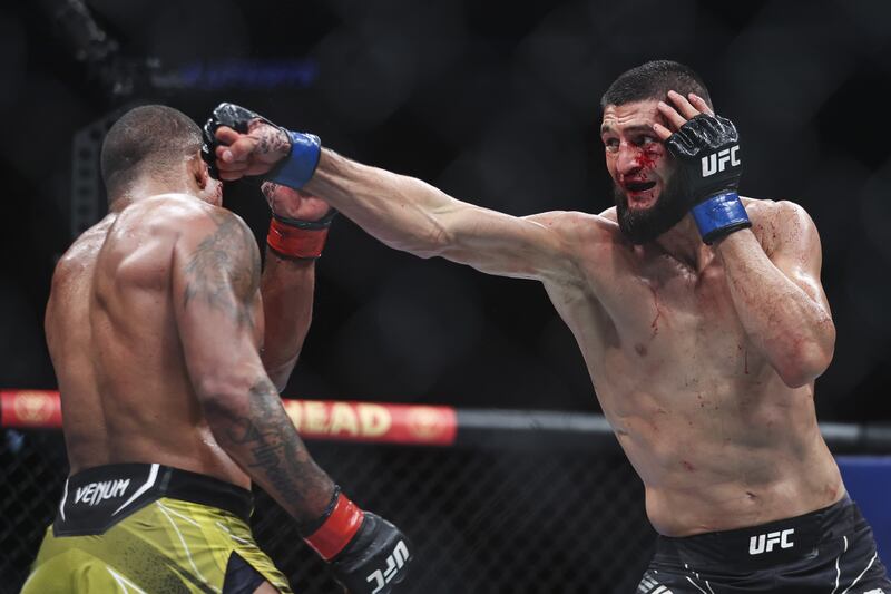 Khamzat Chimaev lands a punch on Gilbert Burns during theirthe welterweight bout at UFC 273. AFP

