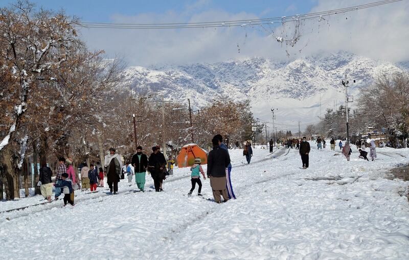 People walk on a snow-covered road in Quetta, capital of Pakistan's southwestern Baluchistan province. AP Photo