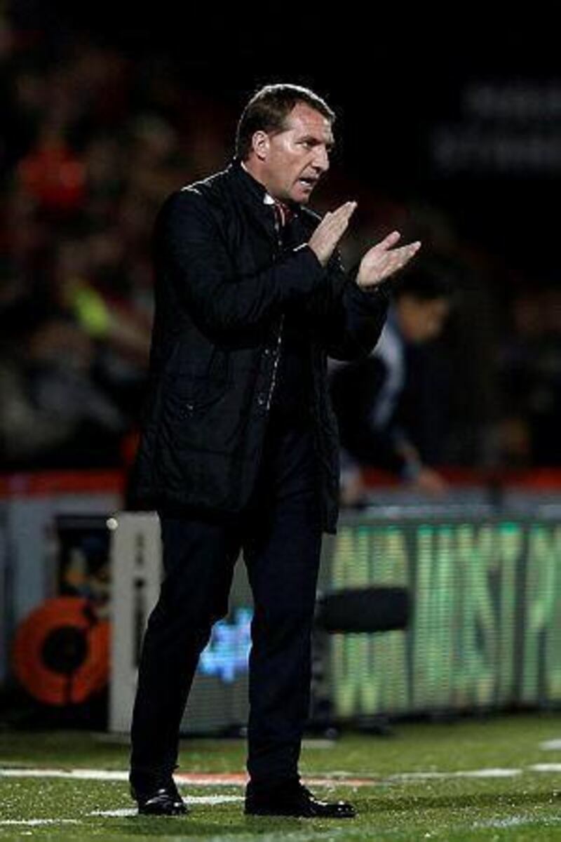 Liverpool manager Brendan Rodgers applauds on the touchline during the English League Cup quarter-final football match between Bournemouth and Liverpool at Goldsands Stadium in Bournemouth, southern England, on December 17, 2014. AFP PHOTO / ADRIAN DENNIS
