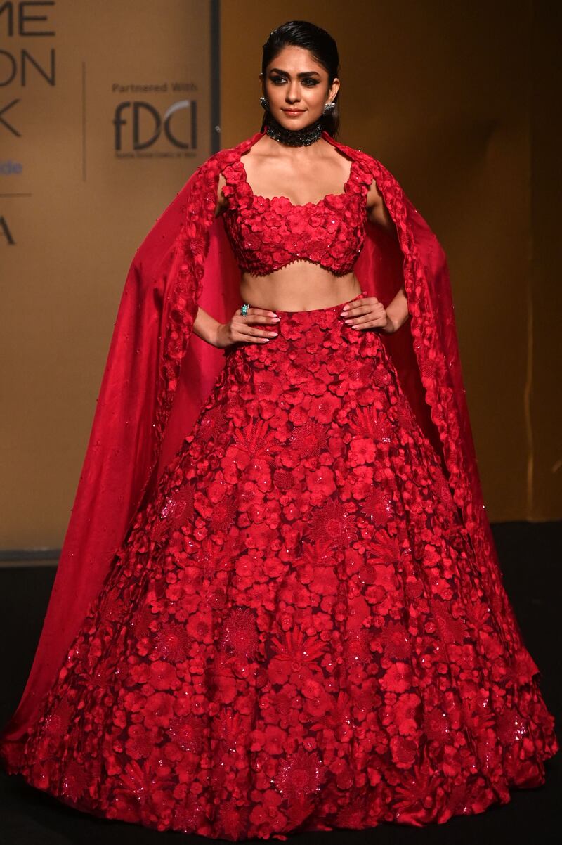 Actress Mrunal Thakur presents a creation by designer Mishru. AFP