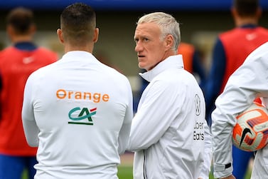 France's head coach Didier Deschamps (C) speaks with staff members during a training session in Clairefontaine-en-Yvelines on September 20, 2022 as part of the team's preparation for the upcoming UEFA Nations League.  (Photo by FRANCK FIFE  /  AFP)