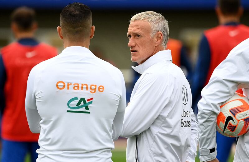 France head coach Didier Deschamps speaks with his staff. AFP