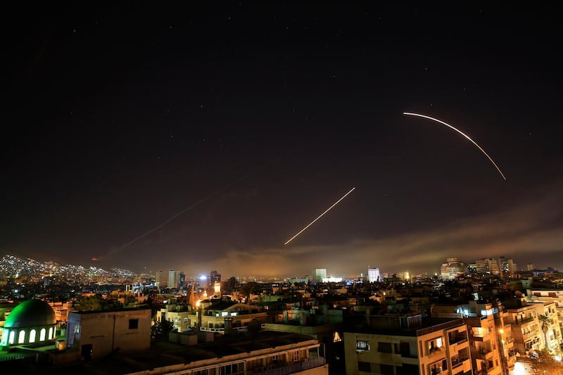 Missiles streak across the Damascus skyline as the US launches an attack on Syria targeting different parts of the capital, early Saturday, April 14, . Hassan Ammar / AP Photo