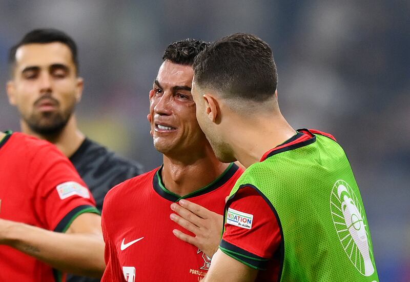 Cristiano Ronaldo of Portugal is consoled by teammate Diogo Dalot as he breaks down in tears after missing a penalty in extra time. Getty Images