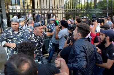 epa07990220 Protesters clash with riot police in front of the Beirut Bar Association building during ongoing anti-government protests in Beirut, Lebanon, 12 November 2019. Protesters demand the president to make parliamentary consultations immediately in order to facilitate the formation of a new government that would replace the recently resigned Cabinet. They also demand the formation of a technocratic government with no political affiliation. Saad Hariri resigned as Prime Minister on 29 October bringing down the entire Cabinet.  EPA/WAEL HAMZEH