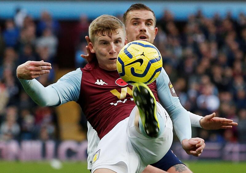 Liverpool's Jordan Henderson battles with Aston Villa's Matt Targett at Villa Park. Reuters