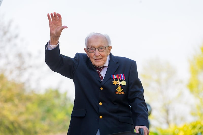 epa08978202 (FILE) 99-year-old British veteran Captain Tom Moore reacts after completing the 100th length of his back garden in Marston Moretaine, Bedfordshire, Britainton Moretaine, Bedfordshire, Britain, 16 April 2020 (reissued 31 January 2021). According to reports, 100-year old Tom Moore, who has raised about 33 million British pounds (almost 37 million euros) for Britain's National Health Service (NHS), was taken to a hospital after contracting coronavirus and having problems with breathing.  EPA/VICKIE FLORES *** Local Caption *** 56097687