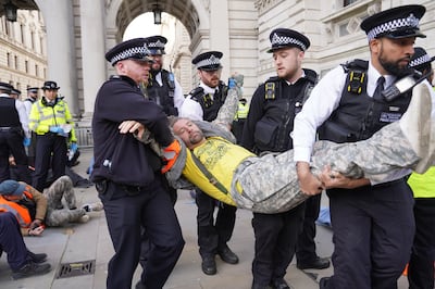 Police remove a Just Stop Oil protester who was detained in Whitehall. PA