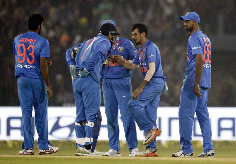 India's Yuzvendra Chahal, second right, celebrates with teammates the dismissal of Sri Lanka's Angelo Mathews during their first Twenty20 international cricket match in Cuttack, India, Wednesday, Dec. 20, 2017. (AP Photo/Bikas Das)