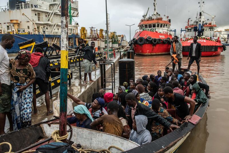 People from the town of Buzi unload from a boat at Beira Port. Getty Images